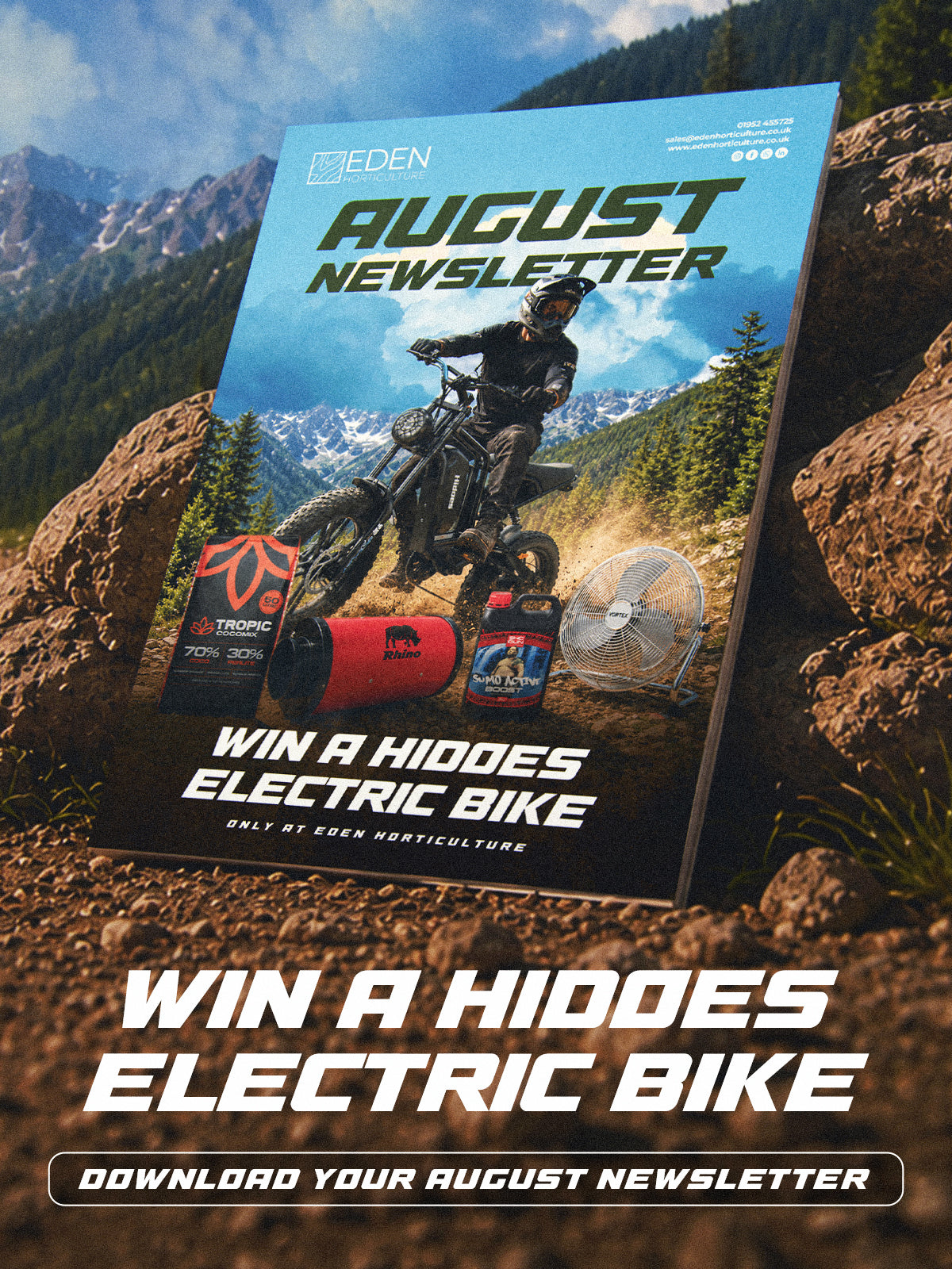 Eden's August Newsletter propped against large rocks in a mountain setting. Win a Hidoes Electric Bike.