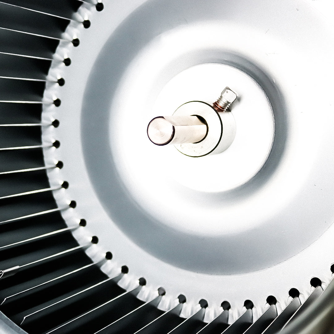 Close-up of internal fan grille and circular hub with metal blade assembly