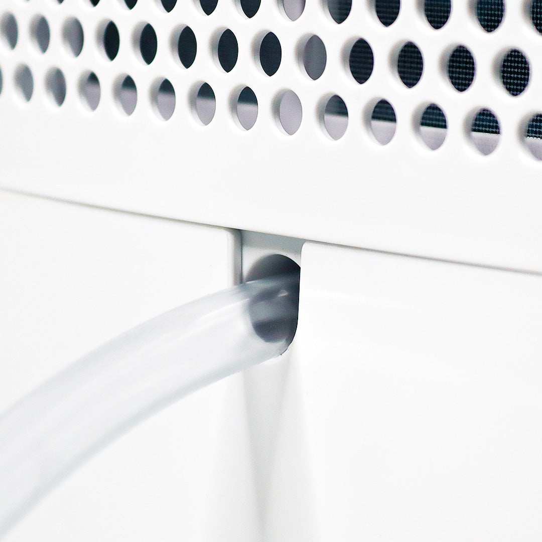 Dehumidifier air outlet vent with curved duct and perforated grille