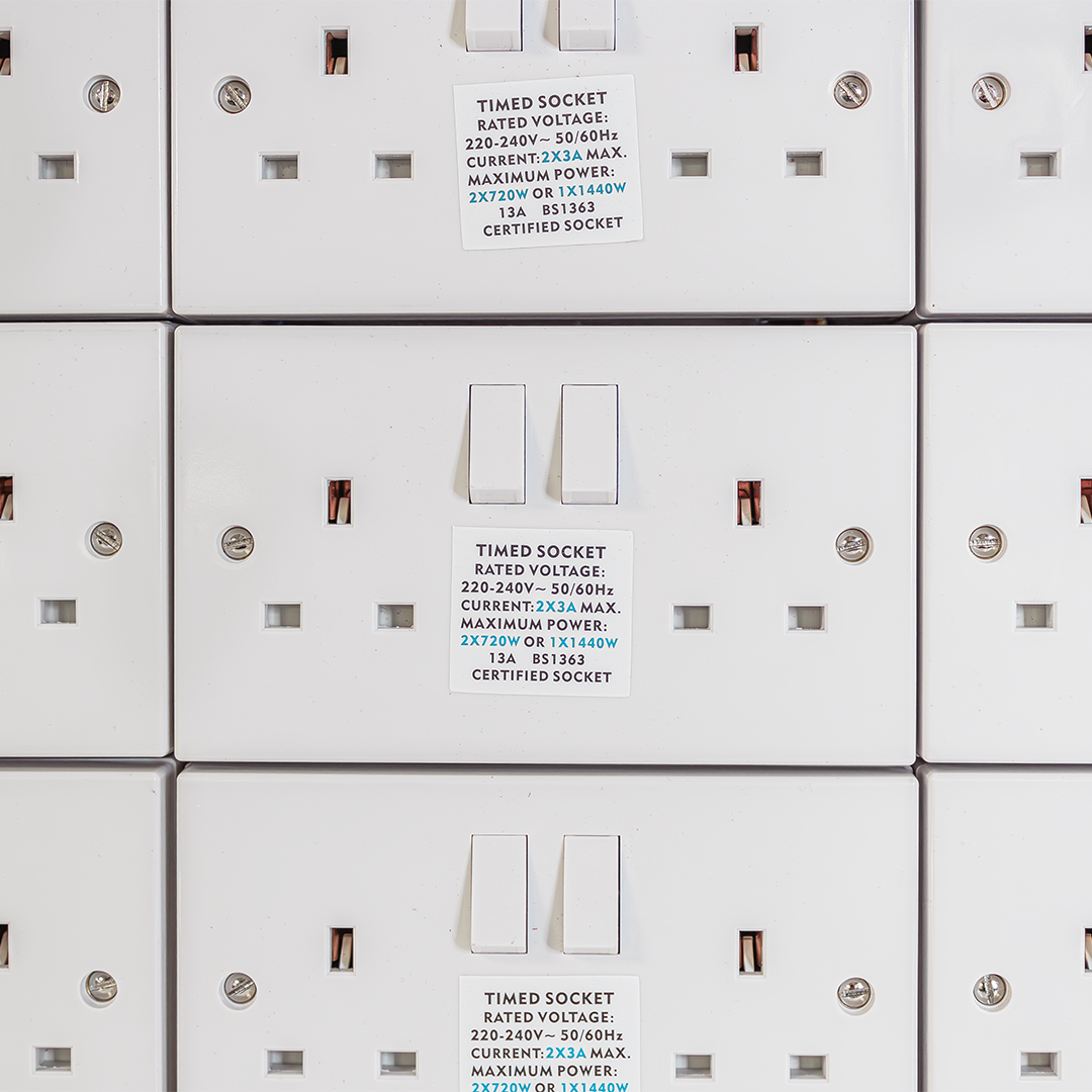 Close-up of white contactor module text and two switch covers