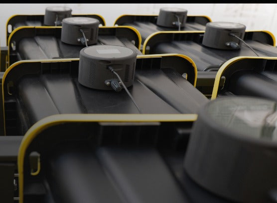 Round sensor puck mounted on top of black chair seat frames in a row
