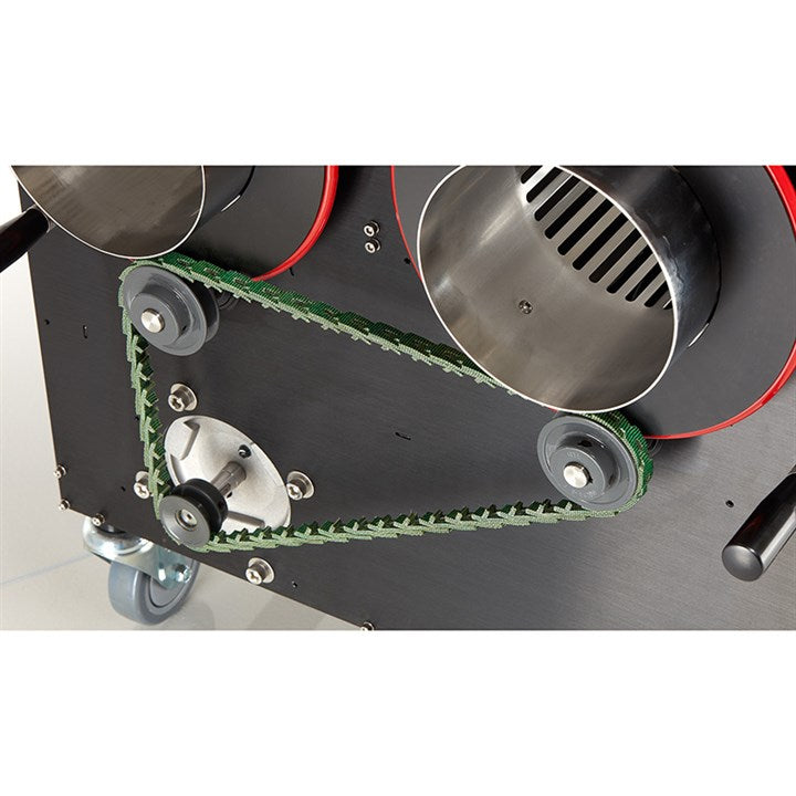 Trimmer machine cutting bed with green material belt, rollers, and metal guards