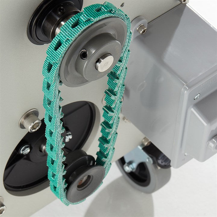 Green braided belt around grey pulleys on the trimmer base