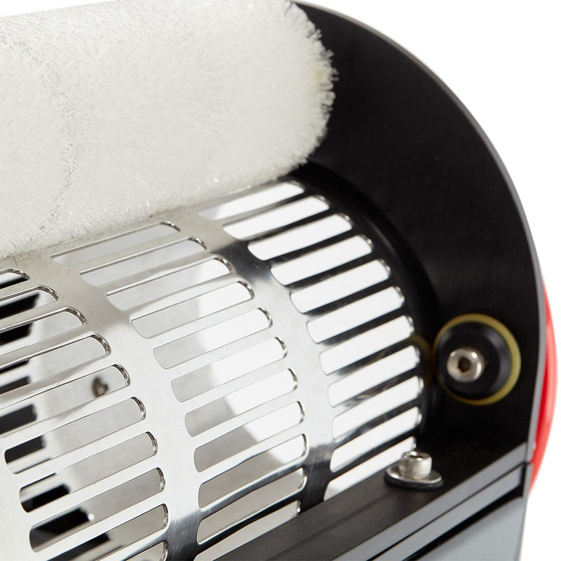 Stainless steel trimming guard near circular blade opening on tabletop trimmer