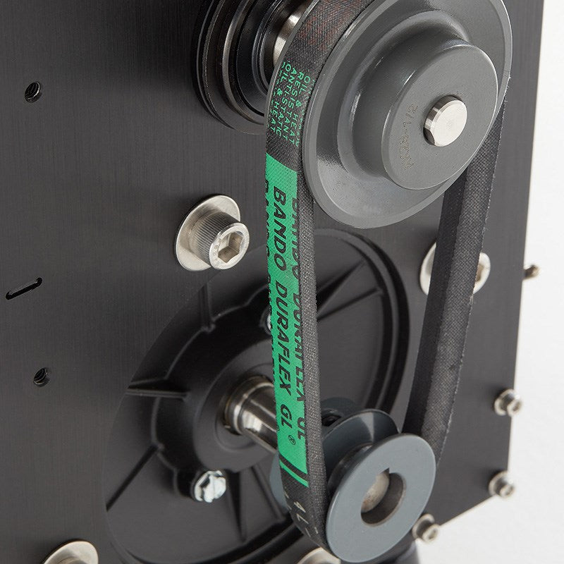 Tabletop trimmer drive area with gray wheels, black housing, and green strap