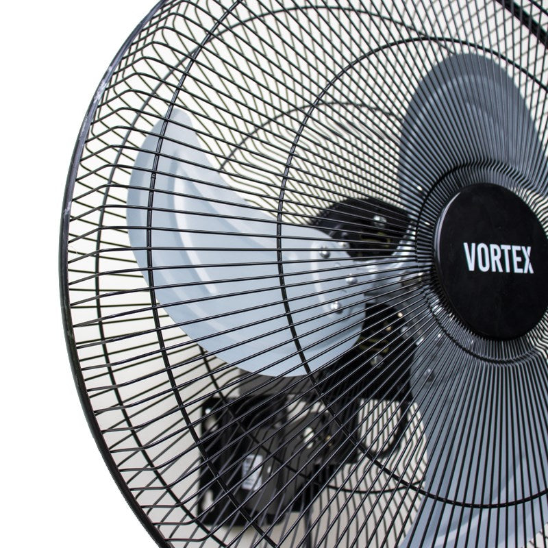 Oscillating wall fan angled view with black blades and front wire grille