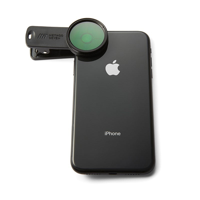 Phone camera lens filter clipped to iPhone, green front lens filter