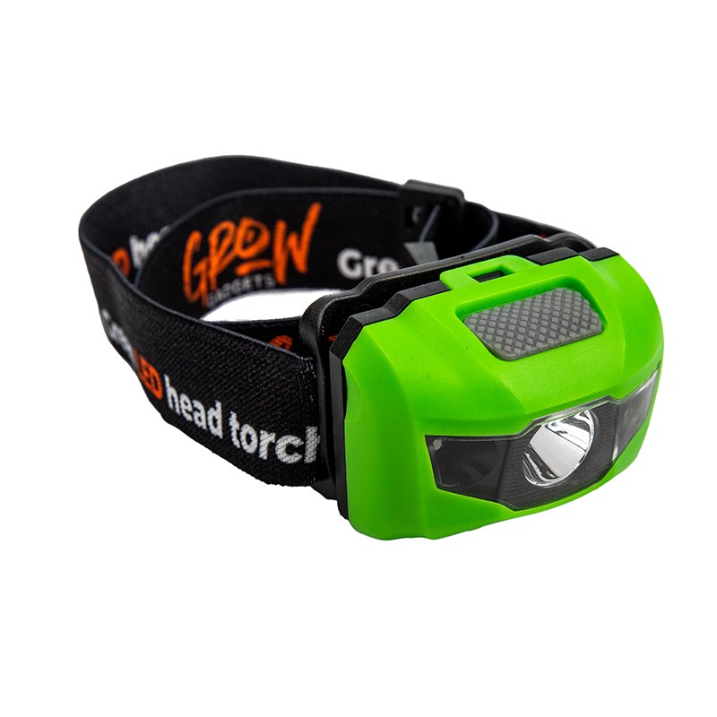 Green LED head torch on black strap, side view with textured switch panel