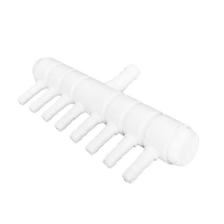 Plastic manifold with white body and clustered hose ports on one side, barbed outlets